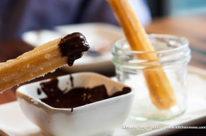 Churros coated with sugar and dark chocolate dip from Iberico